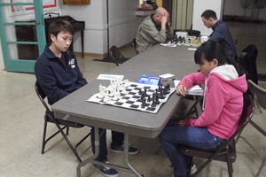 Queena Deng (right) in her win over Master Shijie Chen.